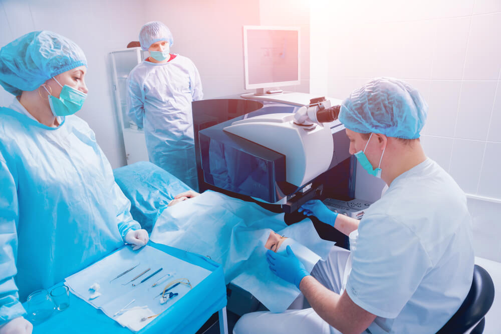 A Patient and Team of Surgeons in the Operating Room During Ophthalmic Surgery. 