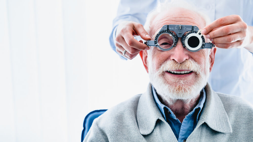 Portrait of a Happy Mature Male Patient Undergoing Vision Check With Special Ophthalmic Glasses