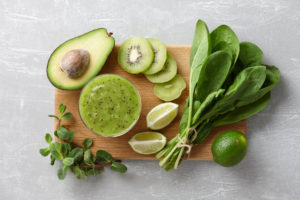 Healthy green smoothie and ingredients kiwi fruit avocado fresh spinach lime mint herb | Diamond Vision