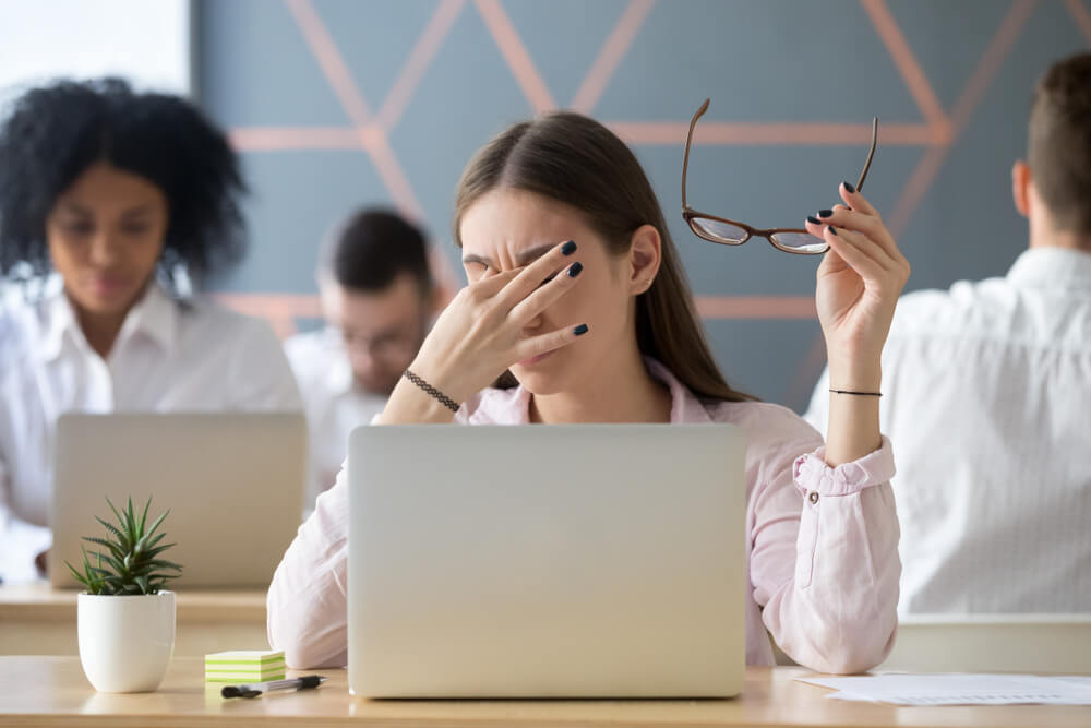 Young Woman Taking off Glasses Tired of Computer Work