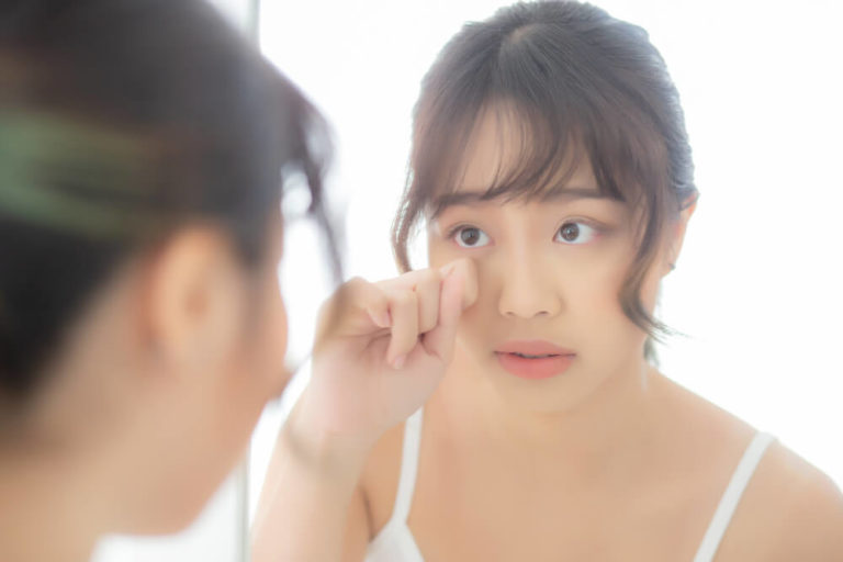 Young Asian Woman Looking Mirror Aging on Face and Touching Eye | Diamond Vision | Diamond Vision