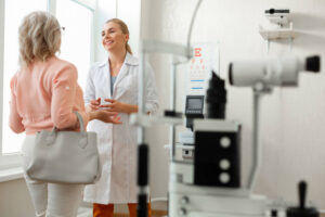 Pleasant Kind Doctor in Long White Robe Talking To Patient While Staying in Spacious Cabinet | Diamond Vision