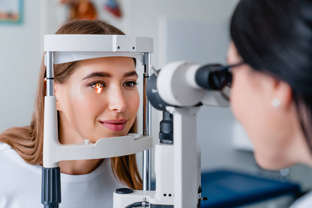 Eye Doctor With Female Patient During an Examination in Modern Clinic | Diamond Vision