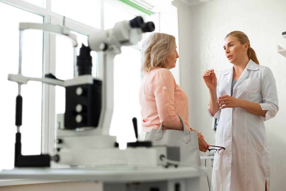 Filled With Technique. Diligent Ophthalmologist Actively Gesturing While Talking With Patient